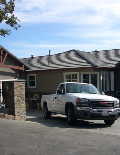 A white truck parked in front of a house.